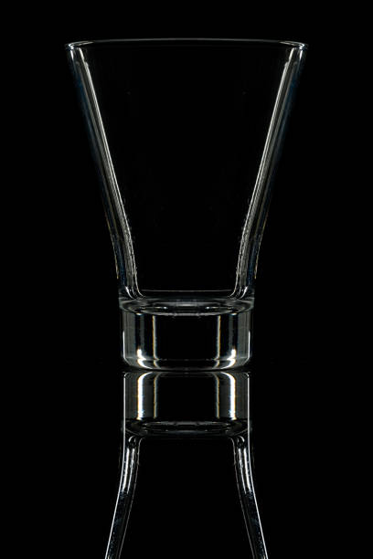 istock cocktail glass on a black mirror with reflection 1387782919