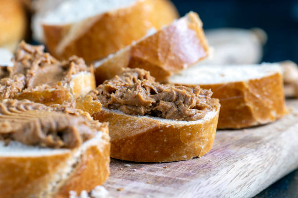 istock peanut paste with pieces of peanuts and white baguette 1387783361