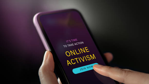 istock Online Activism Concept. Hand Using Mobile Phone to Join an Internet Community for Social Movement. Closeup shot 1387784375