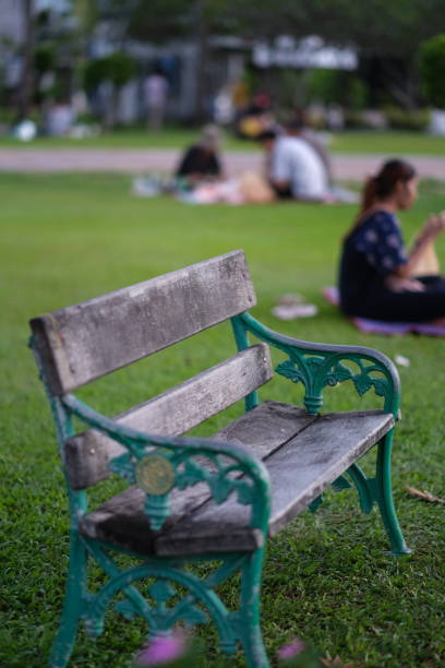 istock Retro-style bench in a public park 1387786113