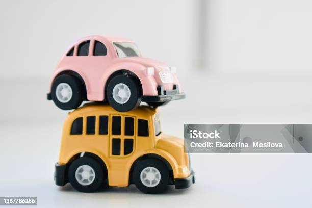 Pink And Yellow Toy Cars On A White Background Closeup With Space For Text Stock Photo - Download Image Now