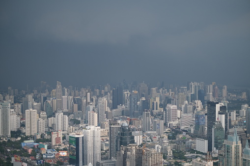 Storm cloud over skyscrapers of Bangkok, aerial view