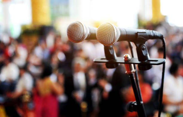 microphone Closeup microphone in auditorium with people. business conference stock pictures, royalty-free photos & images