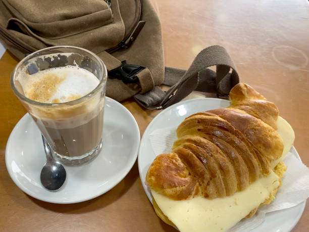 istock Coffee and cheese and ham croissant with rucksack 1387793453