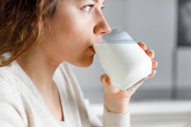 istock Young woman is drinking milk 1387793892