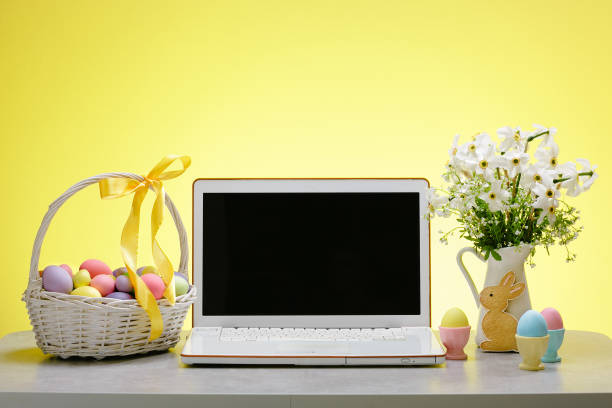 istock A laptop with a blank screen on a table festively decorated for the Easter holiday 1387794685