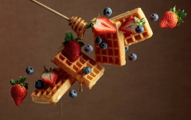 istock Waffles with blueberries, strawberries, and honey. 1387796025