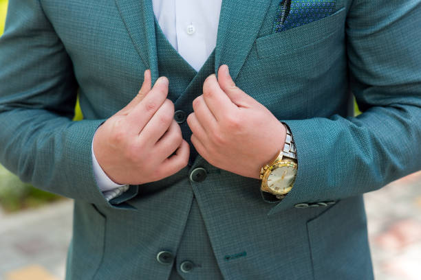 istock A man straightens an elegant suit, close-up 1387797163