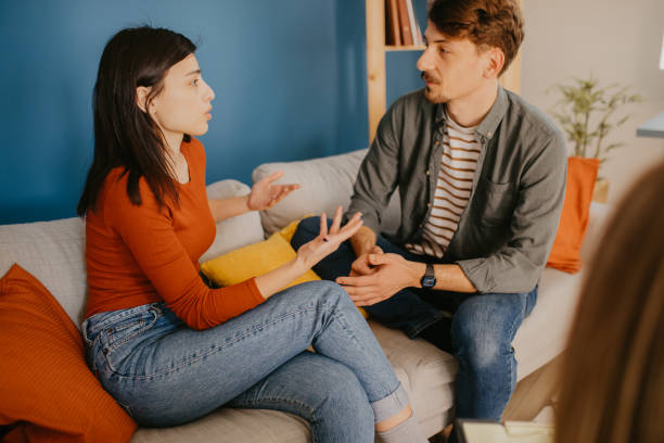 istock Young husband and wife talking to each other on a therapy 1387798883