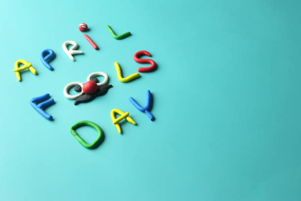 istock April fools day text as joker face on colorful background 1387799091