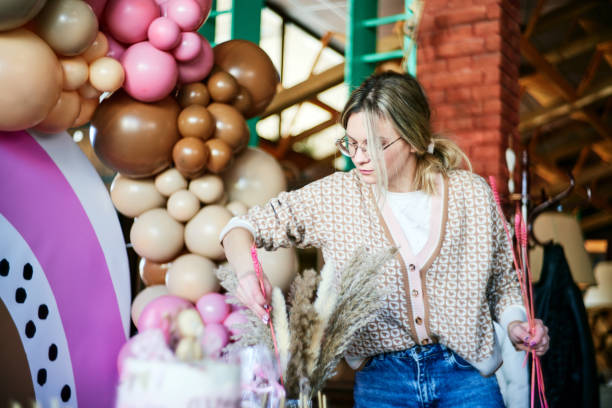 istock Young party planner arranging party decoration 1387799228