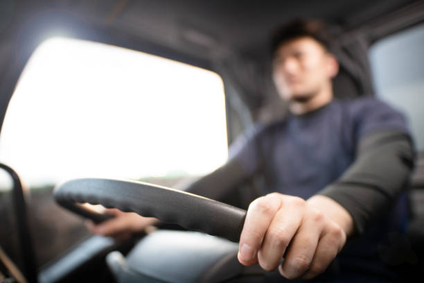 Male hand driving a truck