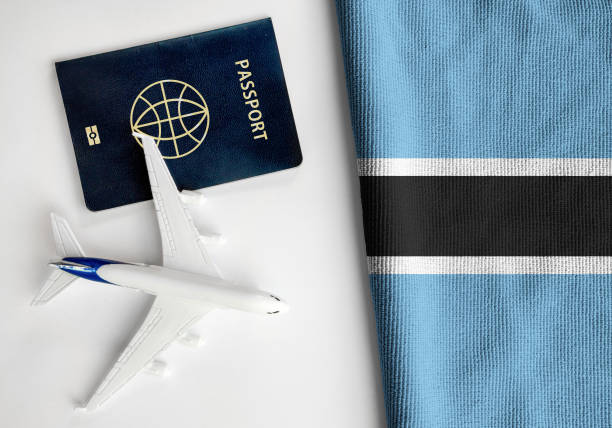 istock Flag of Botswana with passport and toy airplane 1387802441