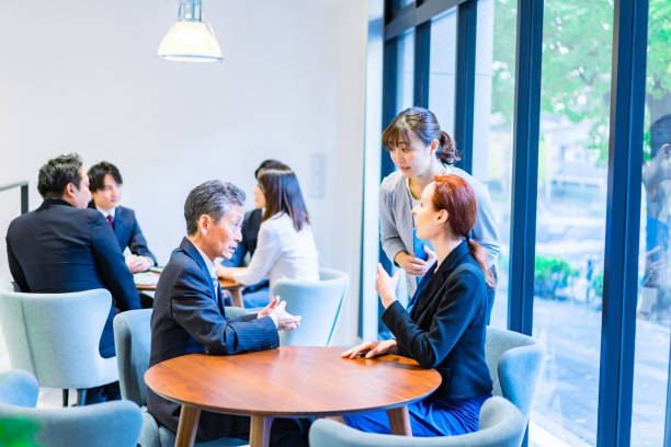 istock Business people talking in an office 1387802505
