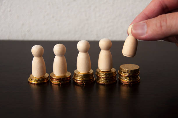 istock Coins Stack with wooden doll model and finger background - Business Concept 1387803322