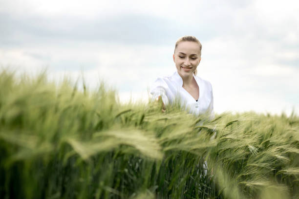 istock Ecologist in a white coat and glasses examining plants 1387804340