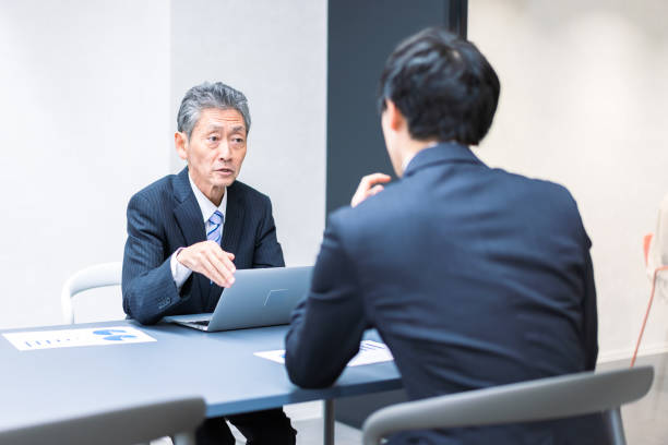 Boss and subordinate having a meeting Boss and subordinate having a meeting subordination stock pictures, royalty-free photos & images