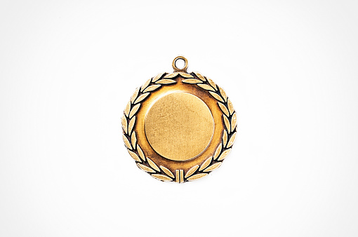 Metal medal with laurel leaves represents the honor of winning.