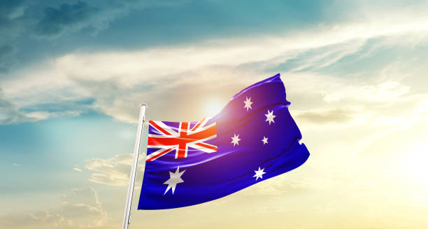 istock Australia flag waving on beautiful sky. 1387808201