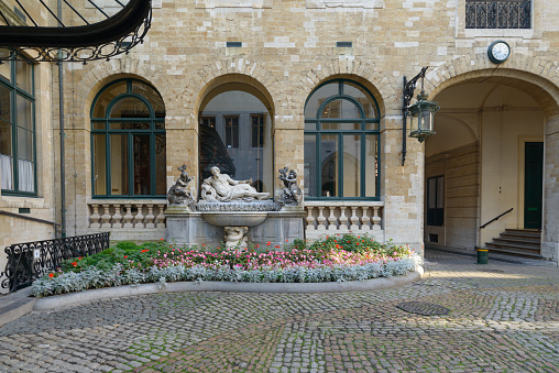 Brussels, Belgium - The Escaut (Scheldt) by Pierre-Denis Plumier - courtyard with a small garden of flowers of the Town Hall