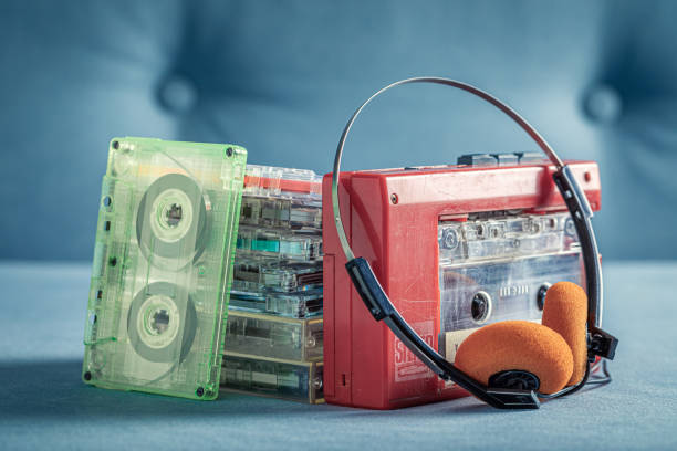 istock Transparent audio cassette with red player and headphones. 1387812650
