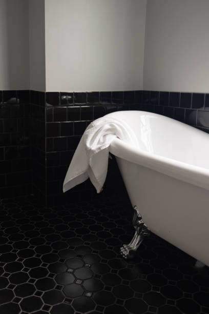 istock A Place For Relaxation: A White Bathtub In A Black-Tiled Bathroom 1387812865