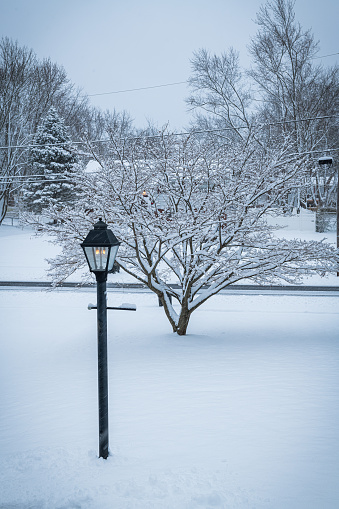 A natural gas latern pole glows during a snowstorm in Manalapan New Jersey.