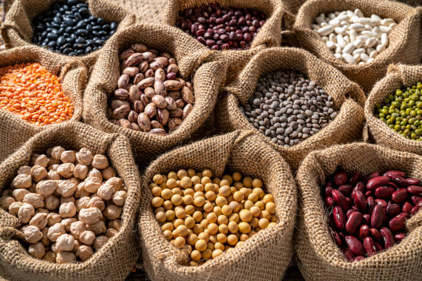 istock Assorted legumes in burlap sacks in a row as a full frame background 1387814774
