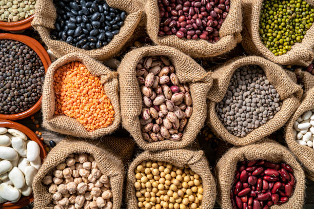 istock Assorted legumes in burlap sacks in a row as a full frame background 1387814836