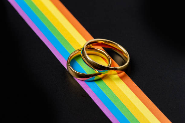 istock wedding rings over rainbow flag 1387816065