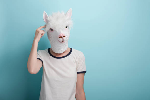 istock Young woman in alpaca mask scratching head, thinking or in doubt 1387816079