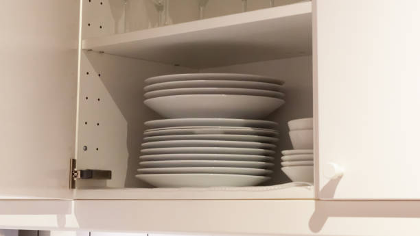istock White cabinets with white crockery in the kitchen, various clean dishes 1387816894
