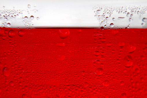 Close up on red cordial syrup drink.