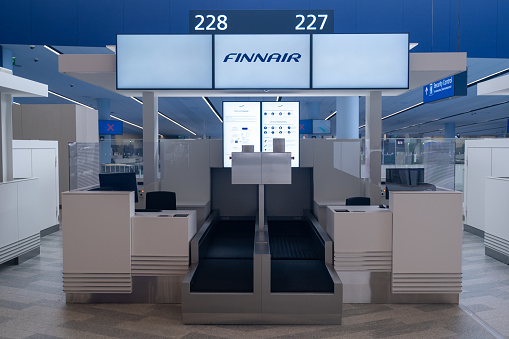 Helsinki / Finland - MARCH 24, 2022: Check-in counter for the Finnish flag carrier Finnair at Helsinki-Vantaa airport.