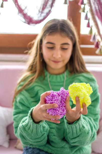 istock Beautiful girl plays with slime 1387824009