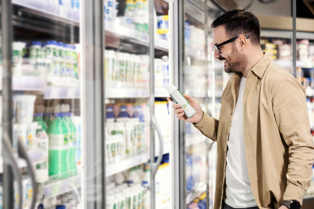 istock A smiling man choosing yoghurt at supermarket. 1387826055