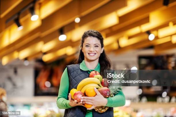 A Supermarket Employee Holding Fresh Fruits Stock Photo - Download Image Now - Supermarket, Employee, Holding