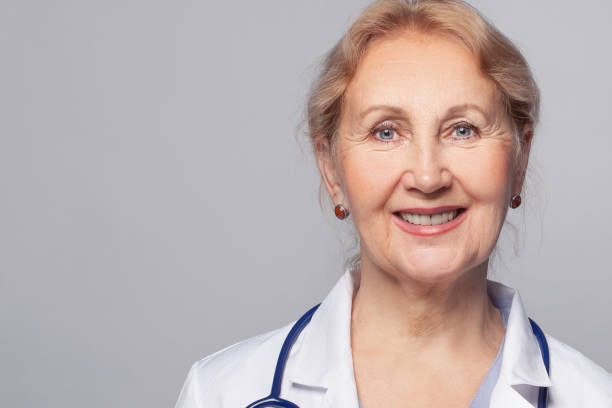istock Smiling medical physician doctor posing on grey background 1387826137