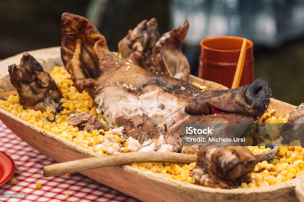 Grilled meat pork head in a wooden traditional plate Grilled meat pork head in a wooden traditional plate on a table in a regional street market festival Barbecue Pork Stock Photo
