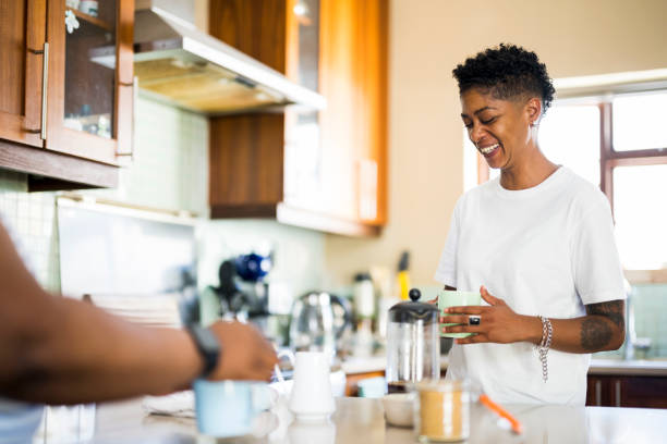 istock Woman having coffee with friend in kitchen 1387830137