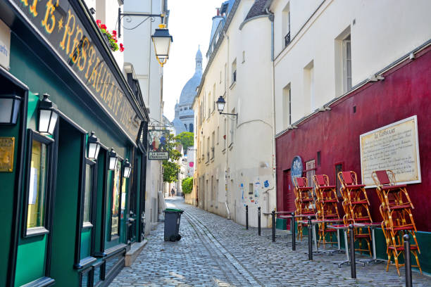 Paris France June 12 2025: Rue de Cardinal Dubois, runs just south and below Sacre Coeur, at the base of a small hill. On the other side of Rue de Cardinal Dubois is the much larger hill of Square Louis Michel.