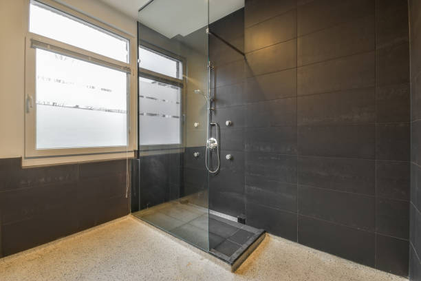 Modern shower cabin with glass door in the bathroom at home