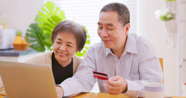 istock elderly couple use credit card 1387834078
