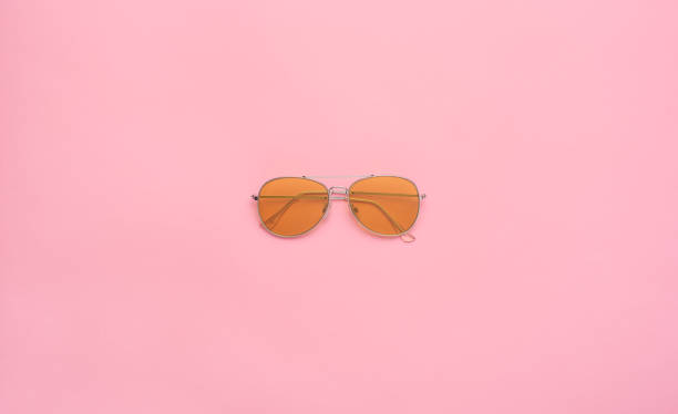 istock Yellow aviator sunglasses (aviators) on a pastel pink background. 1387834214