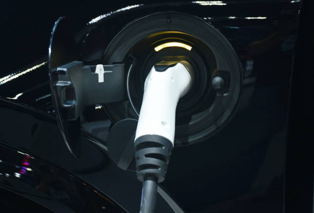 istock plug in electric vehicle charging to electrical car 1387835272