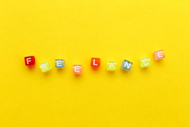 istock word freelance made from multicolored plastic cubes of beads on yellow background 1387835387