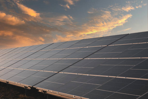 istock Sunset rays over a photovoltaic power plant. 1387836623