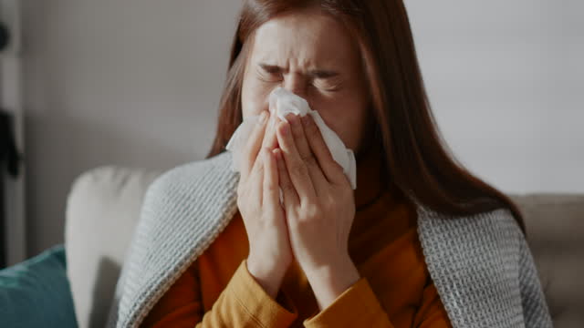 Woman Sneezing and feeling sick