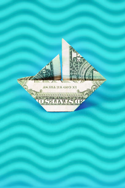 istock US $1 banknote paper boat sailing on stylized waves 1387837685