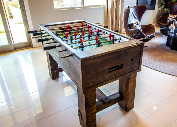 istock Wooden Foosball Gaming Table In Home 1387838706